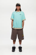 Turquoise polo shirt with checkered collar and sleeves